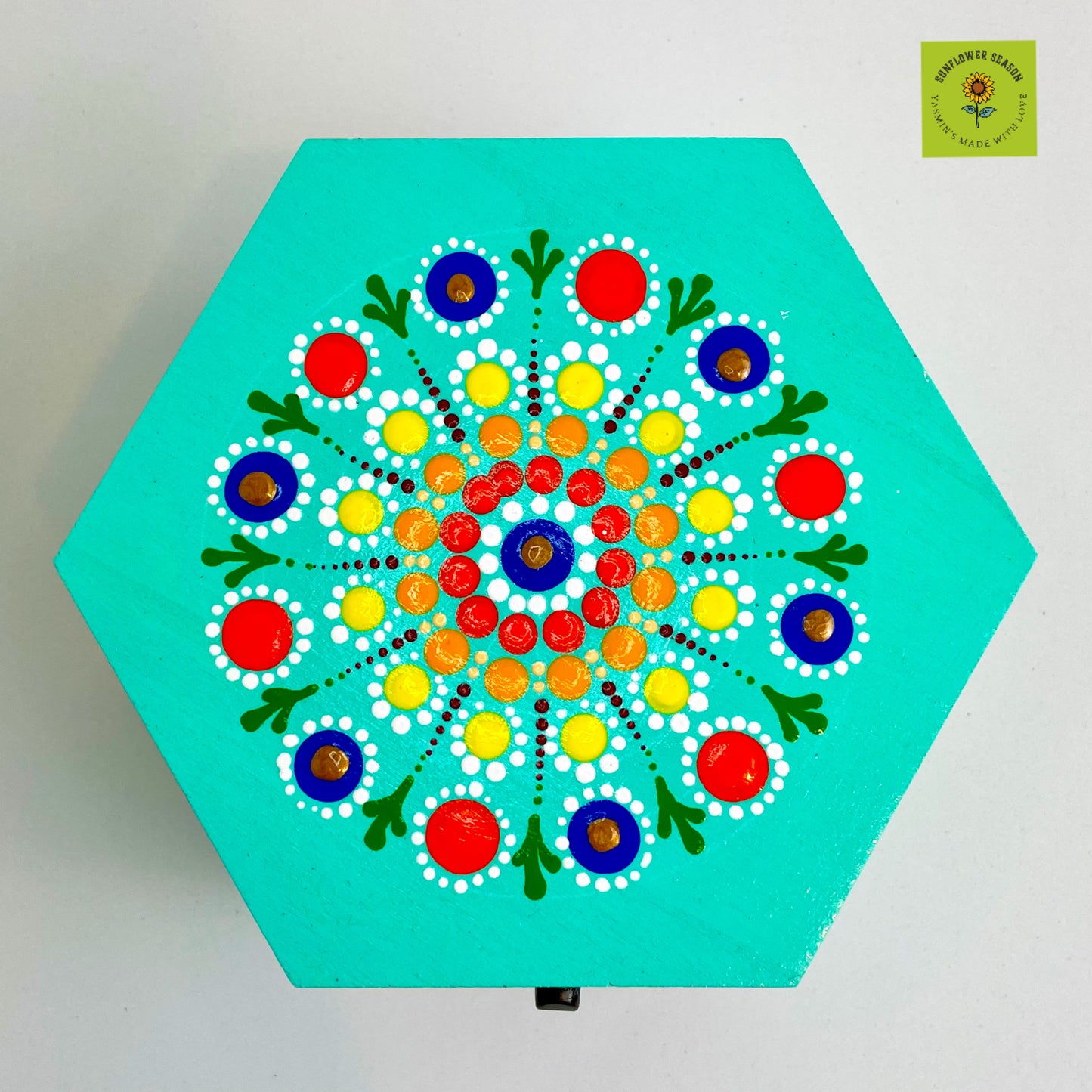 Close-up of sunflower mandala design on hand-painted wooden craft box.