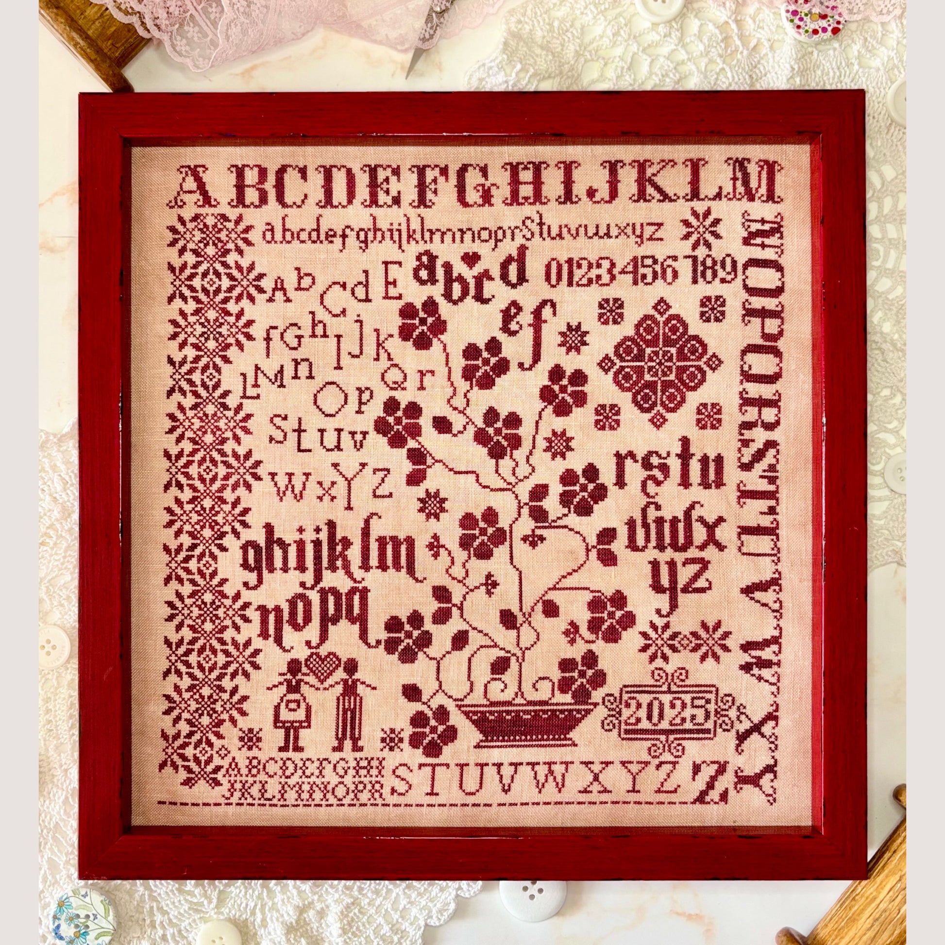 Abecedarian in Red cross-stitch pattern showcasing bold red alphabet letters