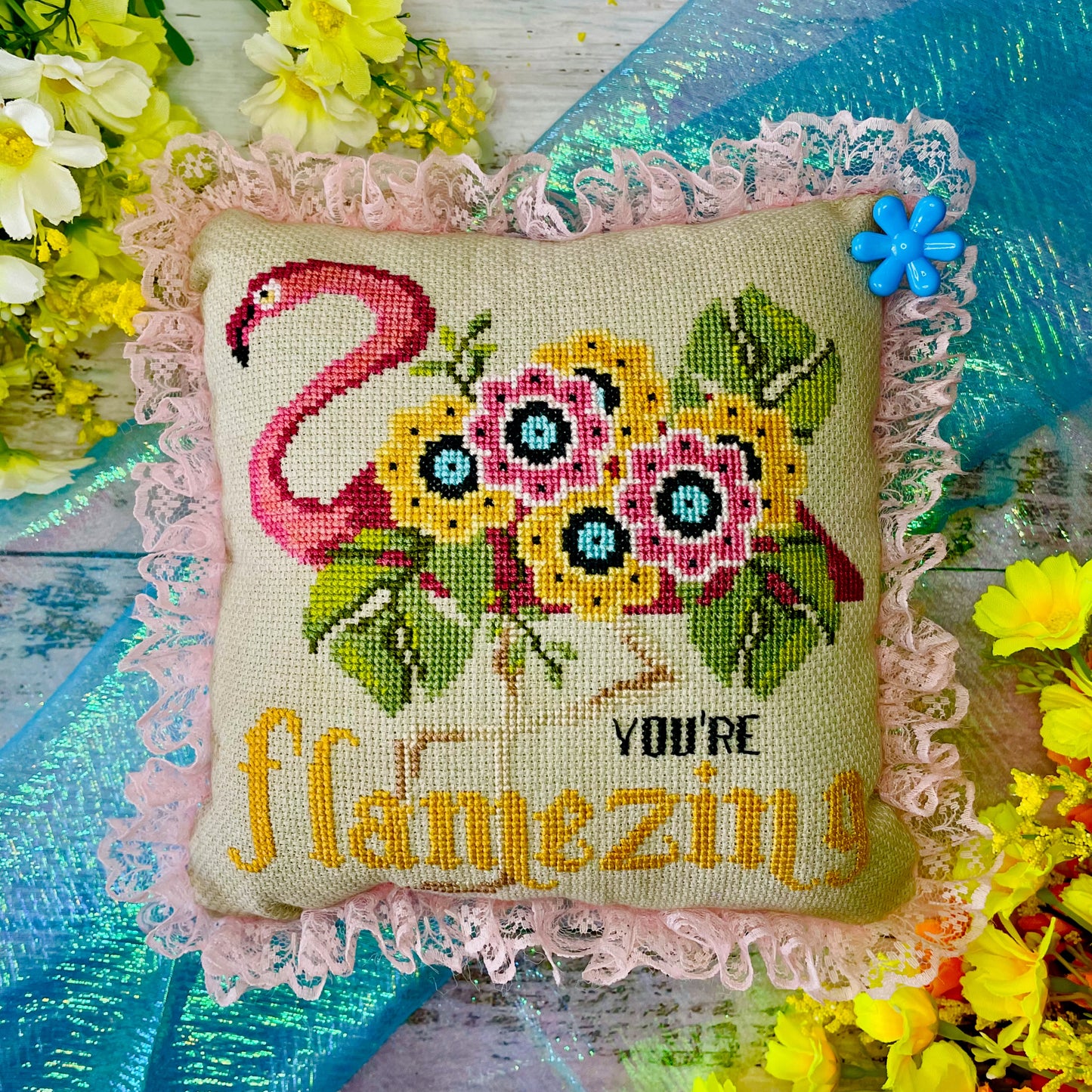Uplifting cross-stitch design featuring flamingo and self-love message
