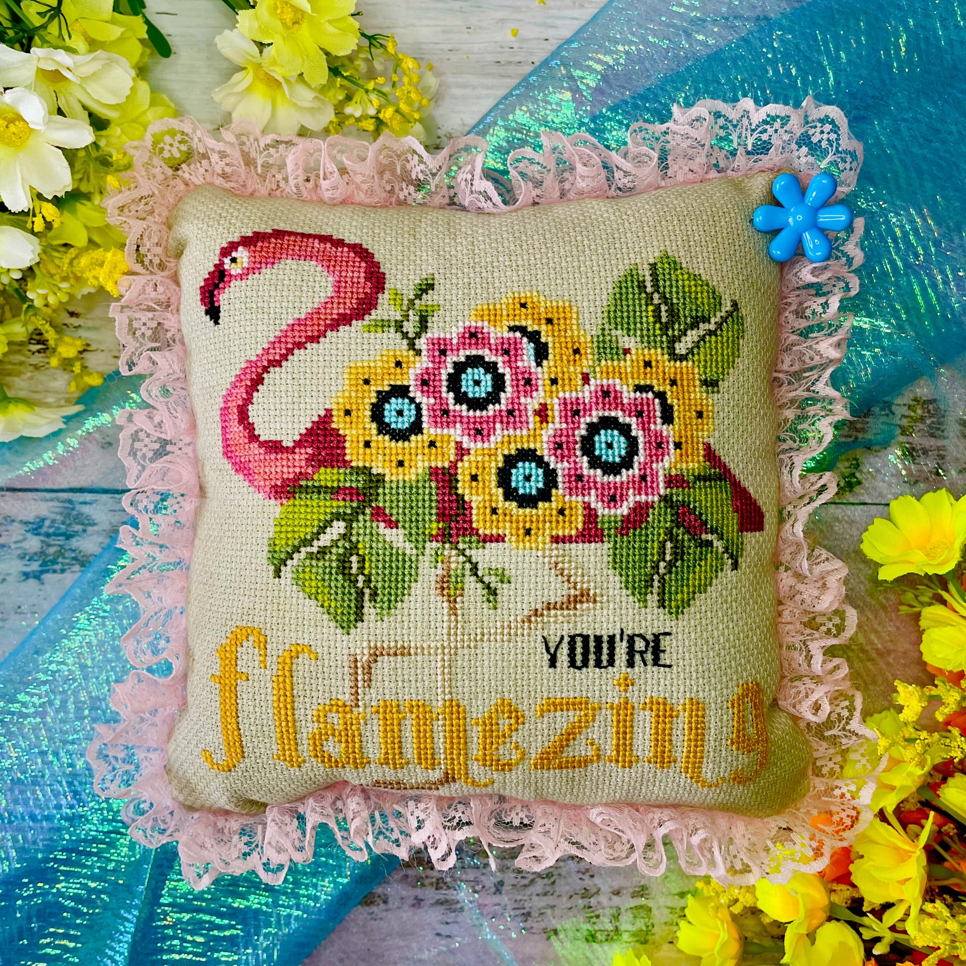 Uplifting cross-stitch design featuring flamingo and self-love message