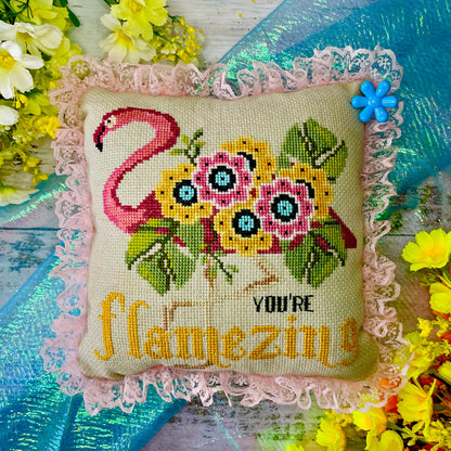 Uplifting cross-stitch design featuring flamingo and self-love message