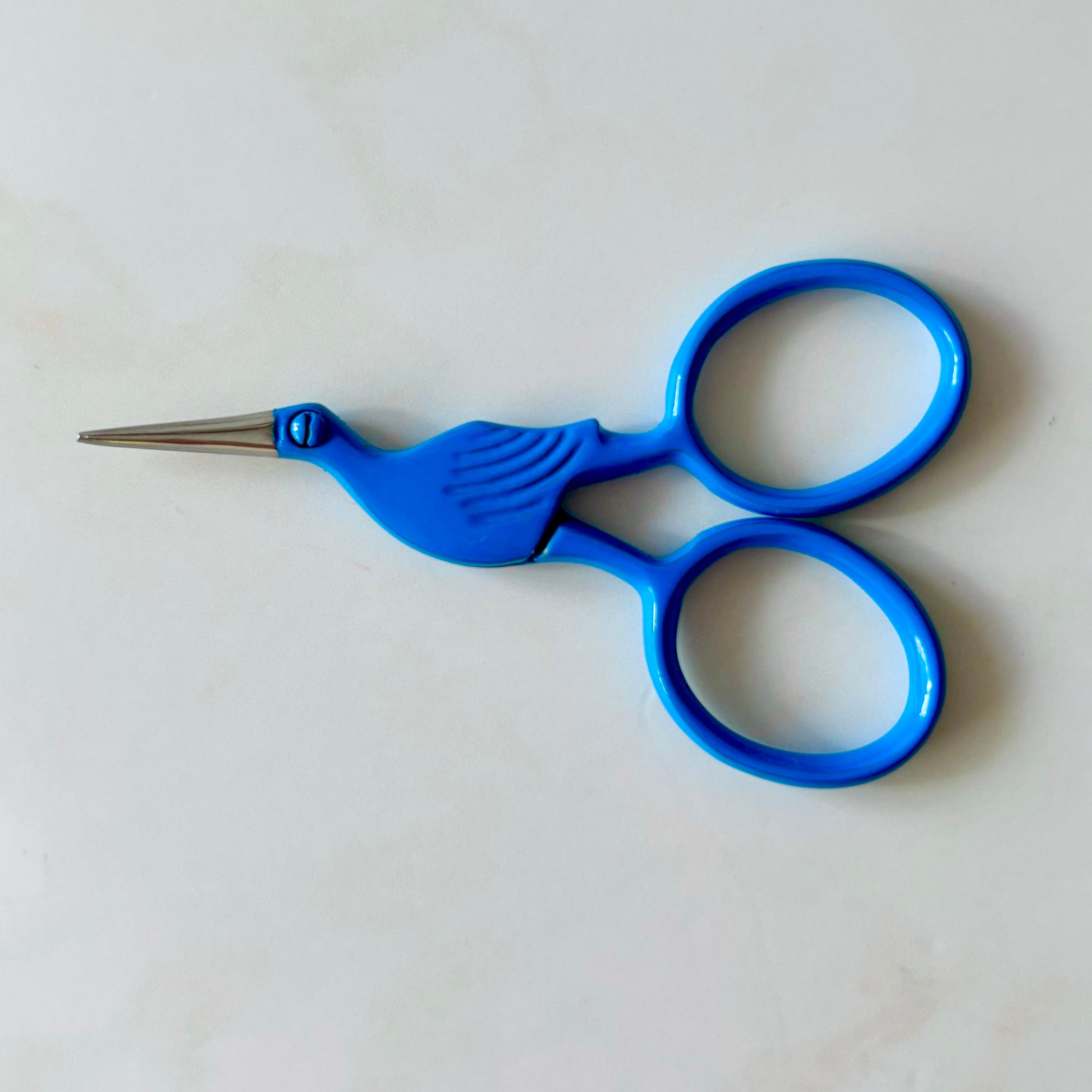 Blue-handled scissors on a white background