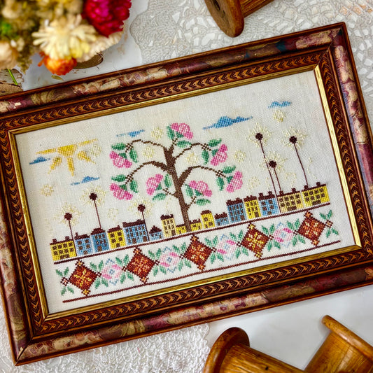 ose Tree Road cross-stitch pattern with floral design in soft pink and green tones