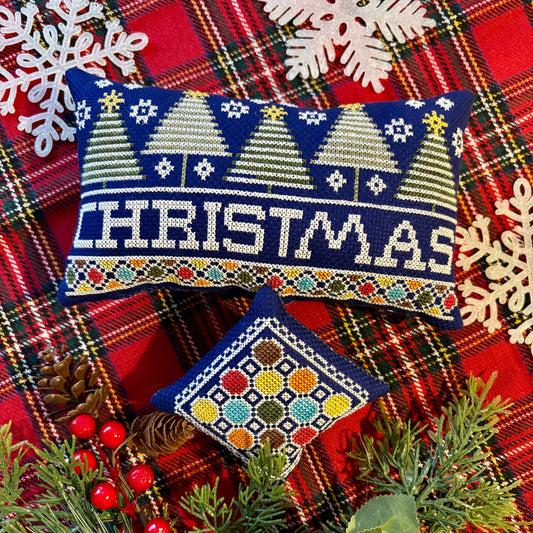 Decorative Christmas pillow with festive design on a plaid fabric background.