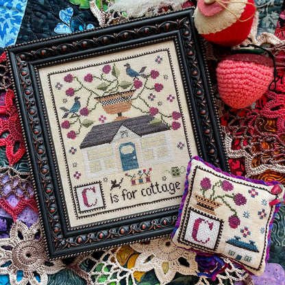 Printed C is for Cottage cross stitch chart featuring a cozy house and alphabet details – physical copy only