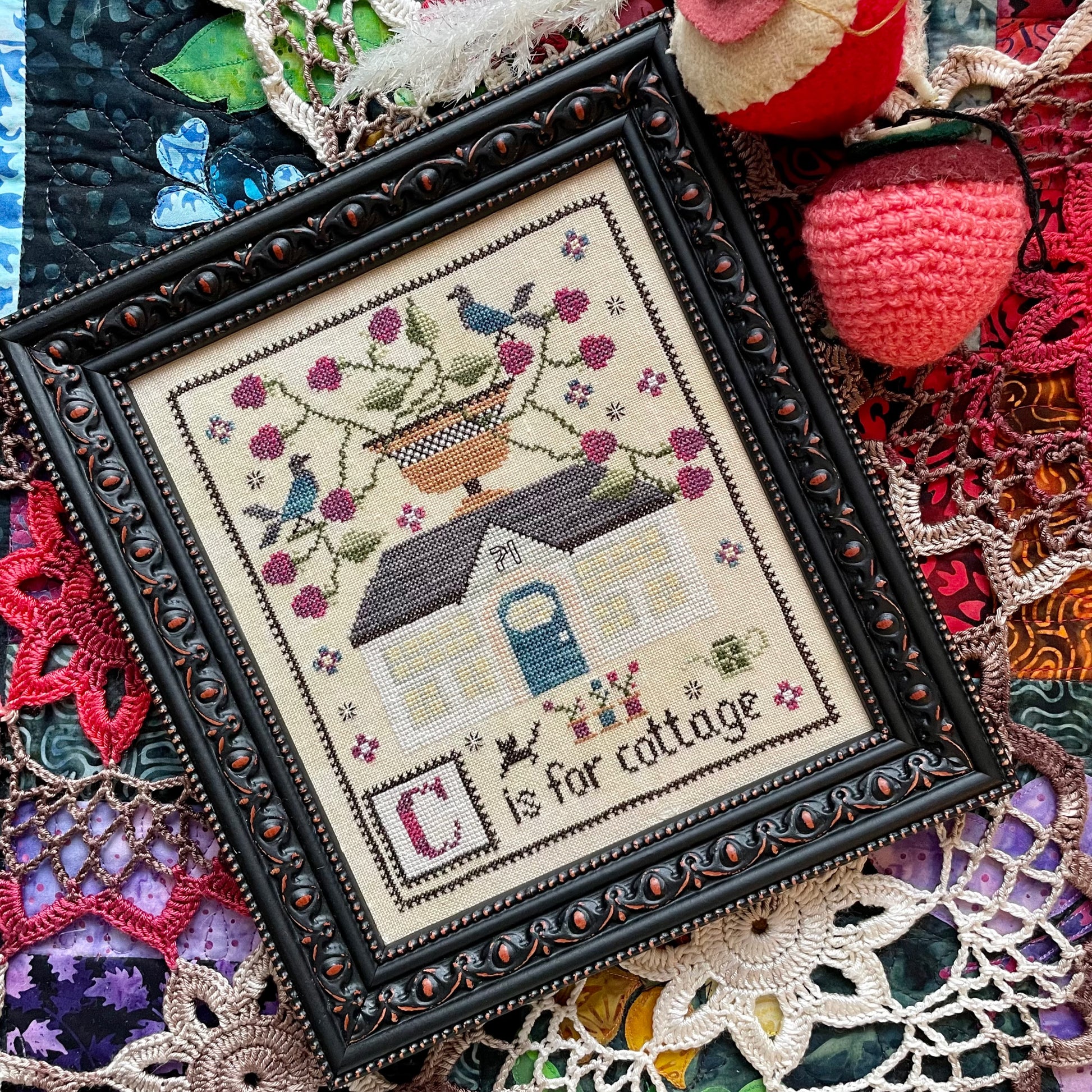 Printed C is for Cottage cross stitch chart featuring a cozy house and alphabet details – physical copy only