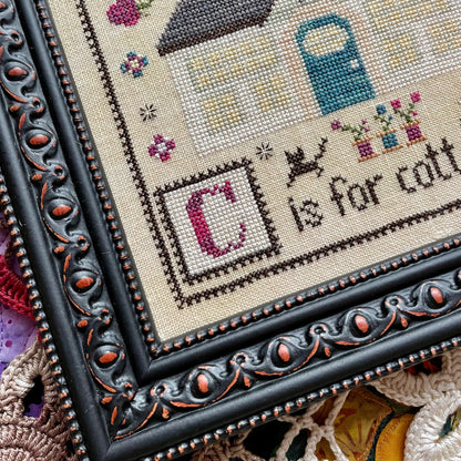 Printed C is for Cottage cross stitch chart featuring a cozy house and alphabet details – physical copy only