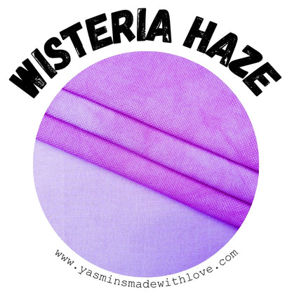 A circular fabric swatch labeled 'WISTERIA HAZE' with a purple and lavender woven textile texture, plus the website www.yasminsmadewithlove.