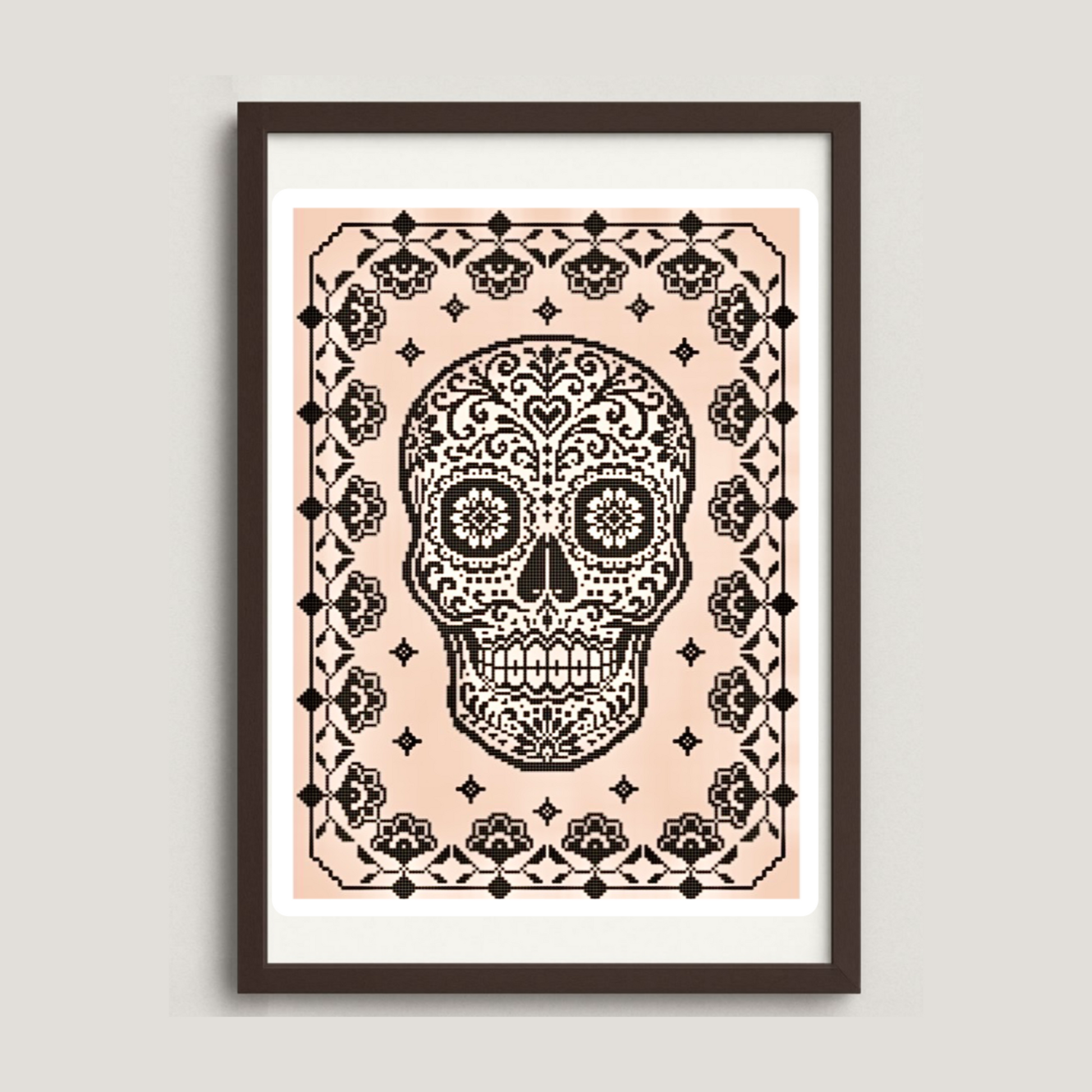 Framed artwork with a black skull design on a pink background
