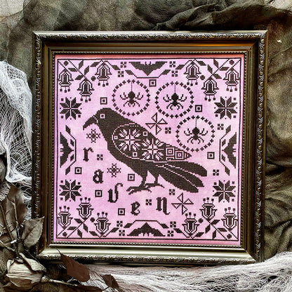 Raven cross-stitch pattern featuring black bird and decorative foliage