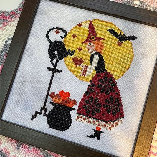 Folk-style romantic cross-stitch with witches, hearts, and symmetrical motifs