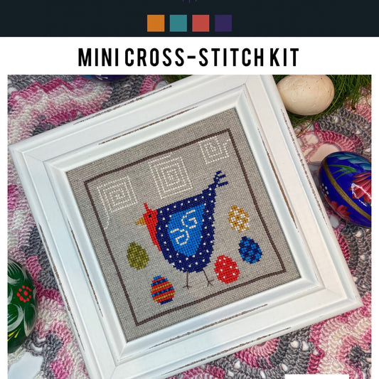 Mini cross-stitch kit with a blue bird design on a textured fabric background