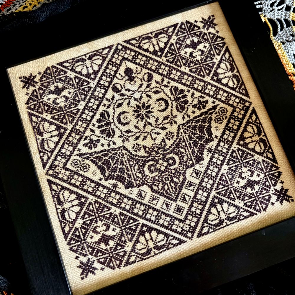 Decorative black and white patterned fabric on a dark background
