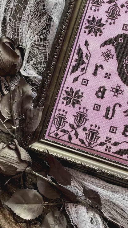 Raven cross-stitch pattern featuring black bird and decorative foliage